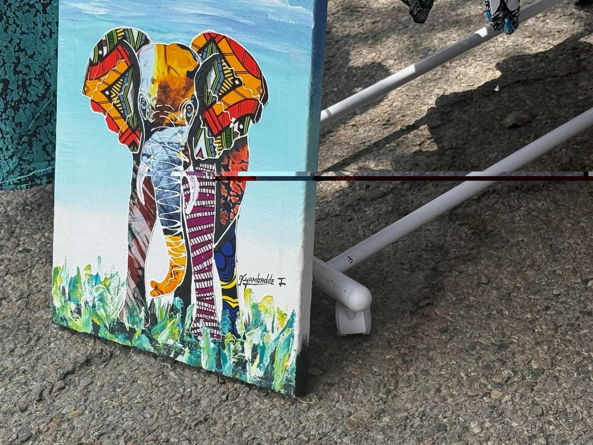 Mixed-media painting of an elephant with a body made of patchwork wax-print fabric, signed Kyambadde