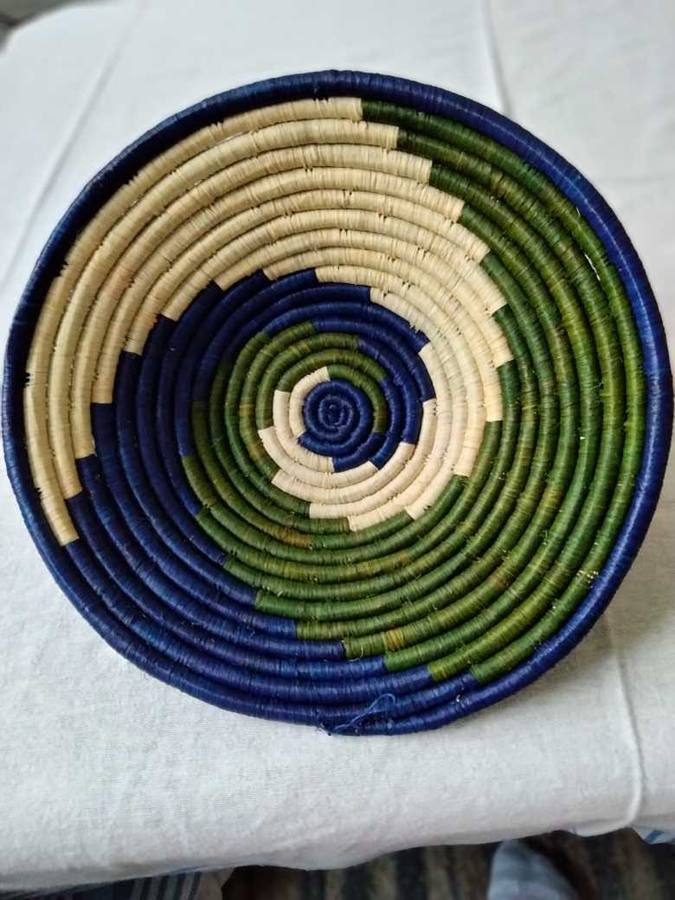 Indigo and olive woven raffia bowl with cream spiral pattern