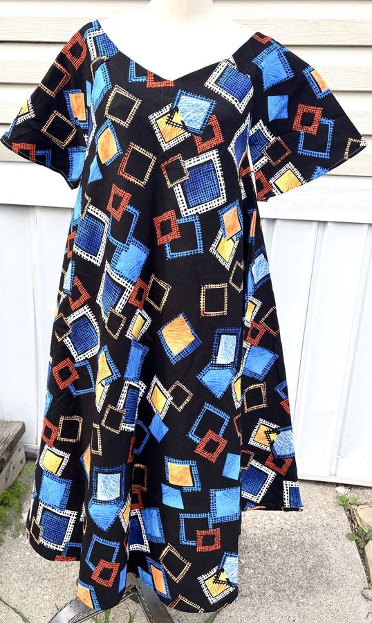 Black dress with a colorful blue, orange, and yellow mosaic square pattern