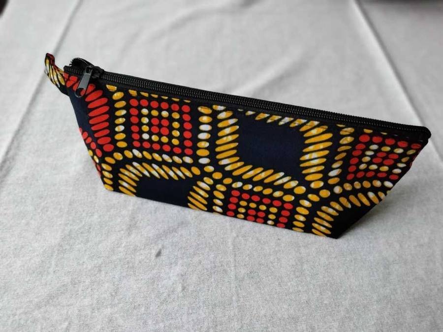 Navy zippered pouch with red, yellow, and cream dot pattern