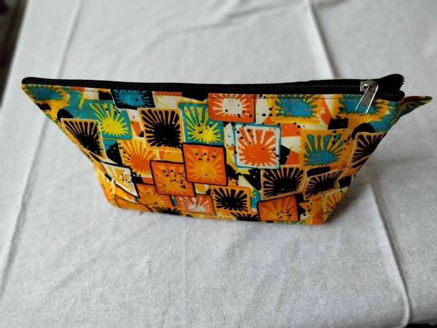 Yellow and teal sunburst pattern zippered pouch
