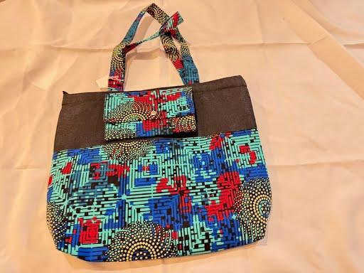 Teal, blue, and red circuit-pattern tote bag with a charcoal panel and matching clutch